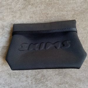 Skims Embossed Logo Clutch